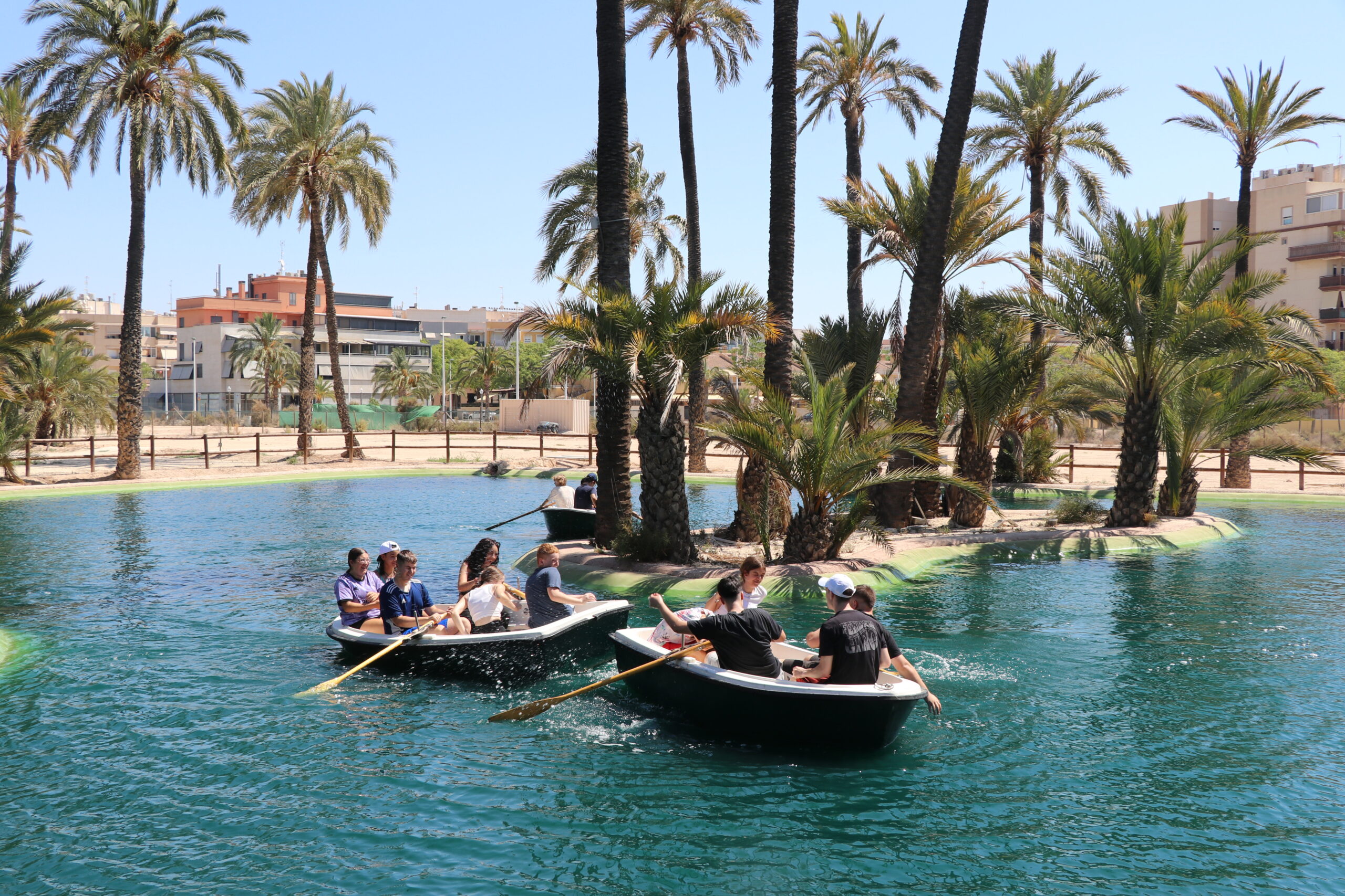 Niños navegando en barcas por el lago del parque multiaventura de Elche